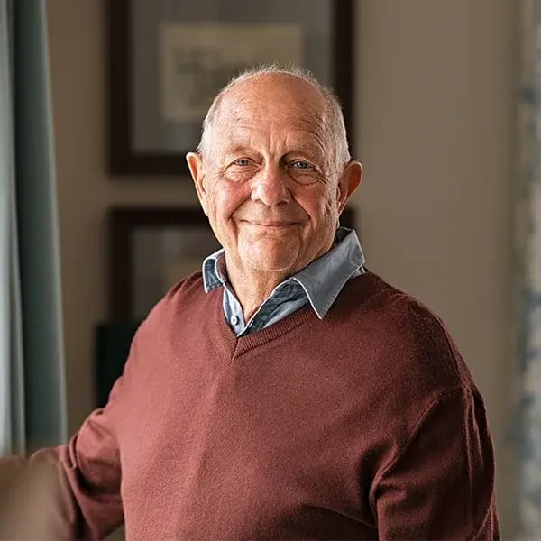Happy senior man looking at the camera at home.